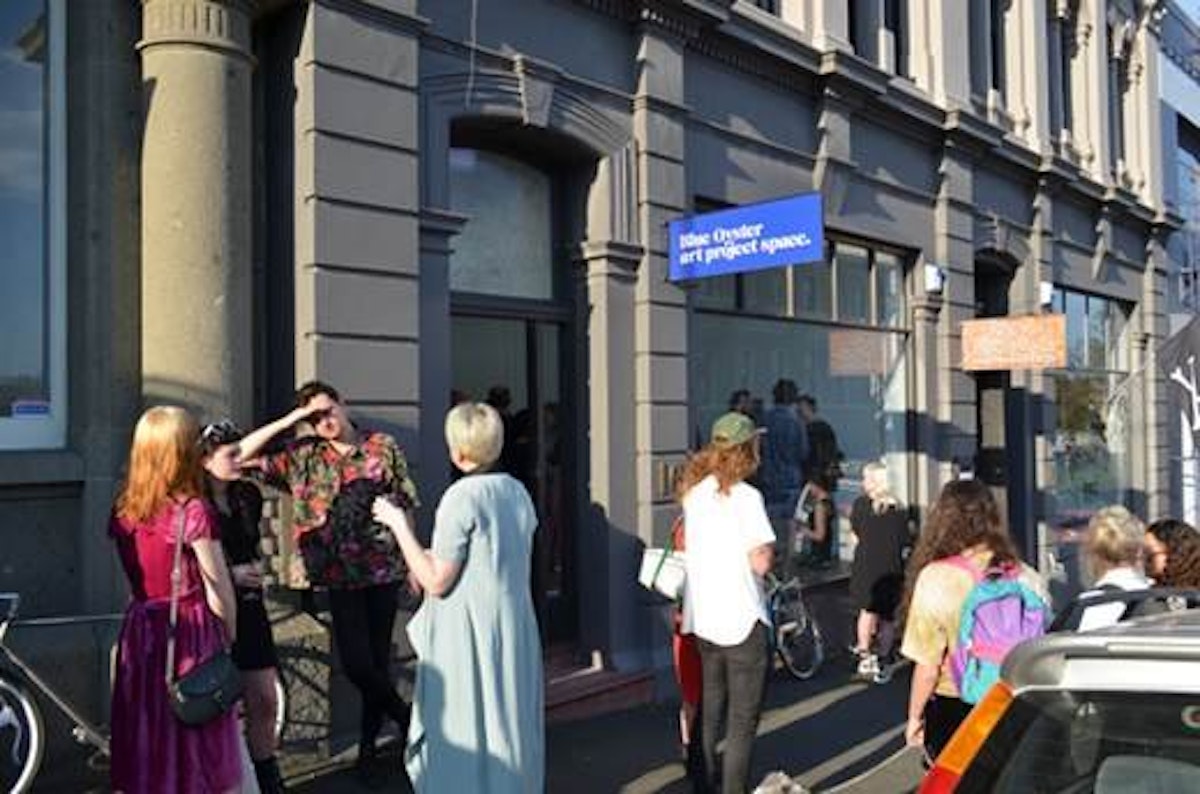 People mulling about outside Blue Oyster gallery in Dunedin